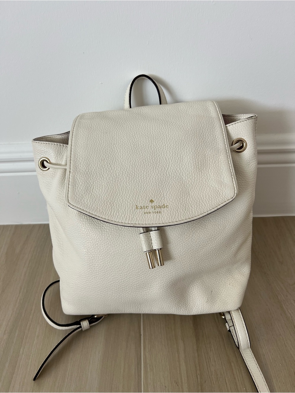 Kate Spade New York creamy white leather drawstring flap backpack